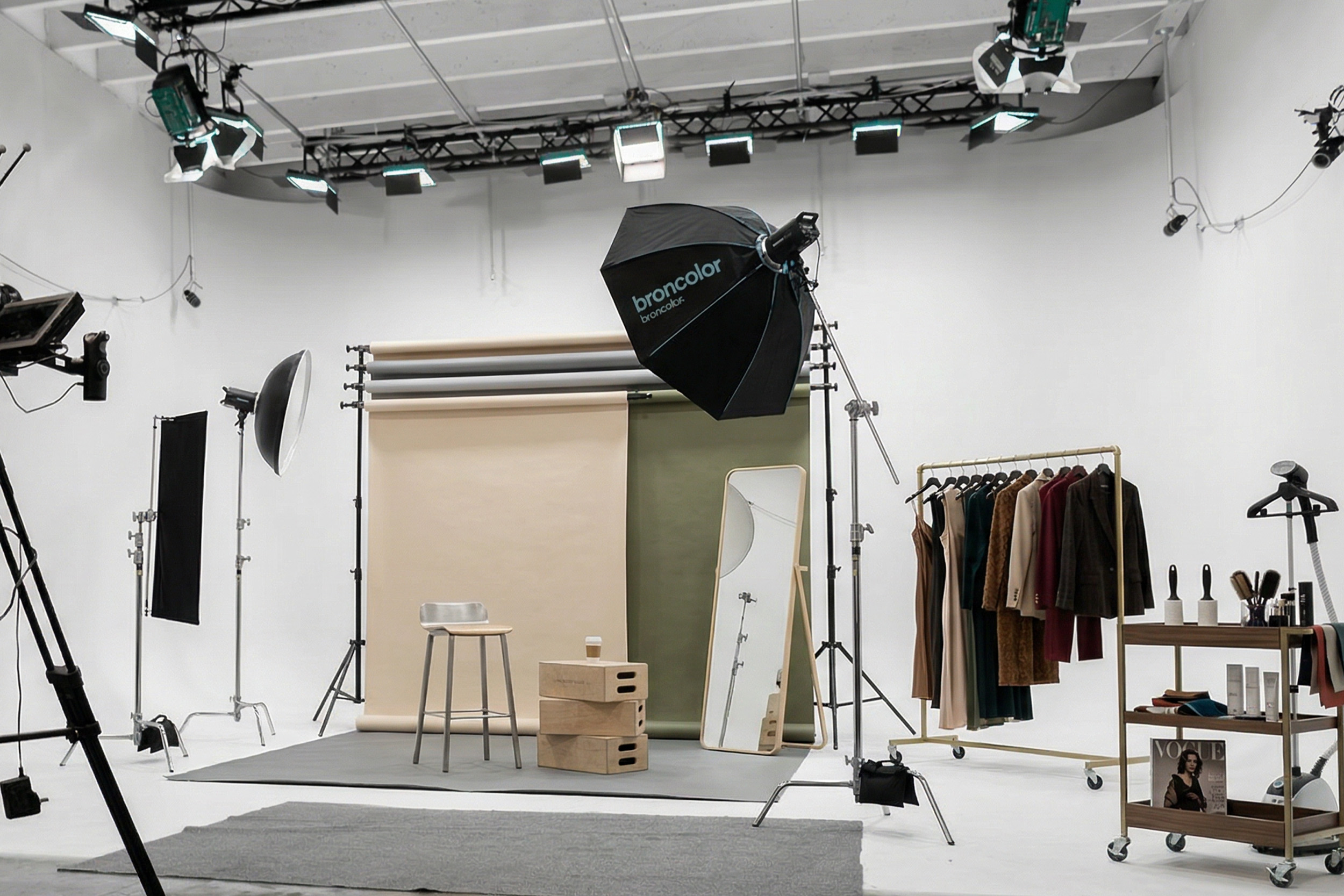 Fashion editorial photography set in a Miami production studio with backdrops, lighting, styling rack, and makeup station
