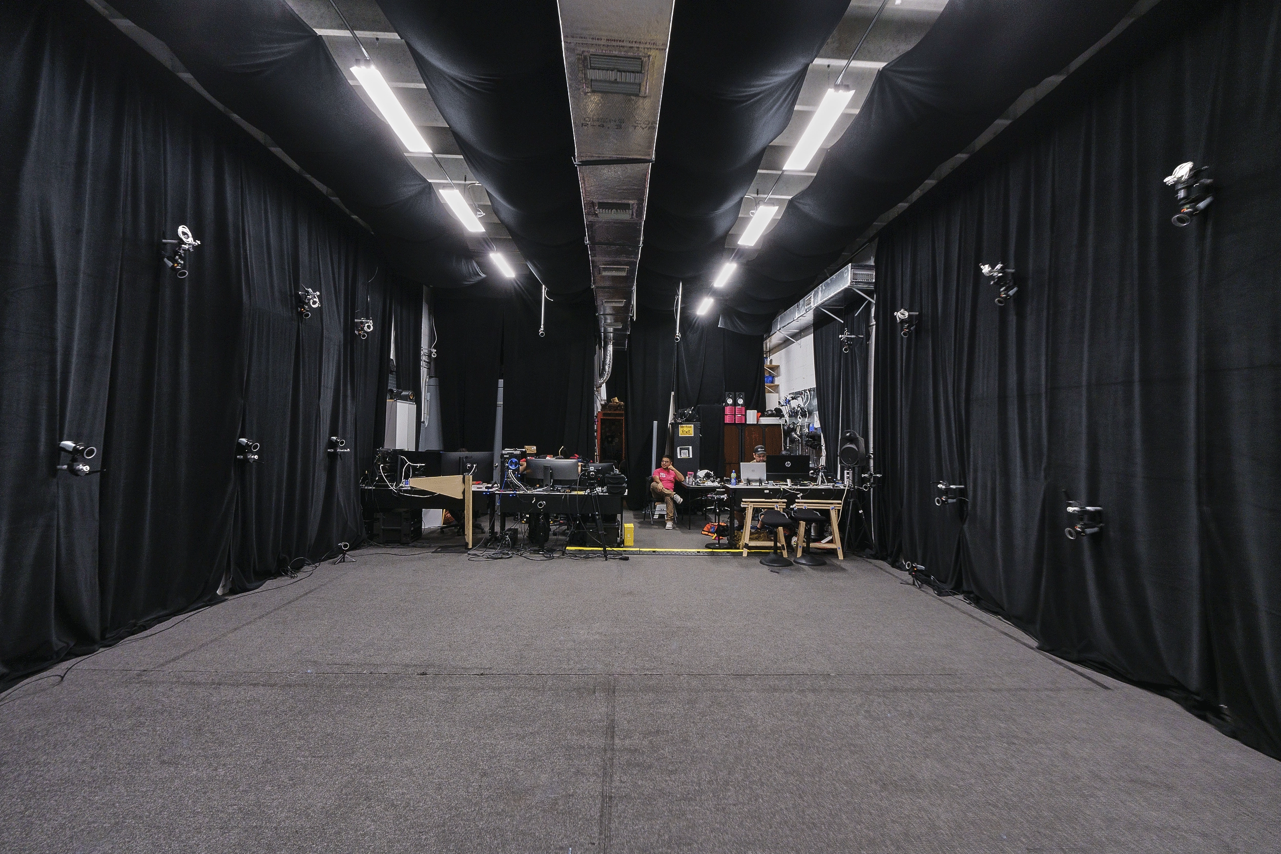 Miami production studio rental with black drapes, open floor space, and lighting setup
