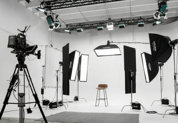 Commercial photo set in a Miami production studio with professional lighting, softboxes, and camera equipment