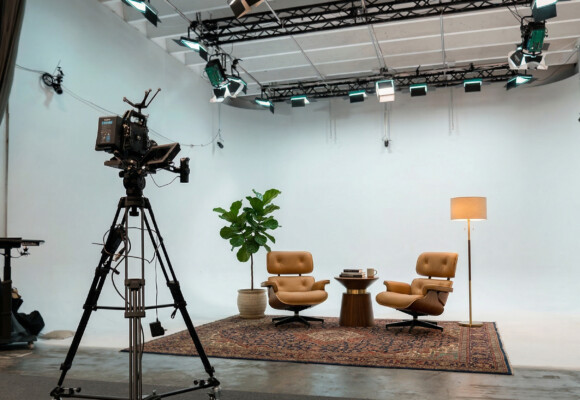Podcast and interview set in a Miami production studio with professional lighting and camera equipment