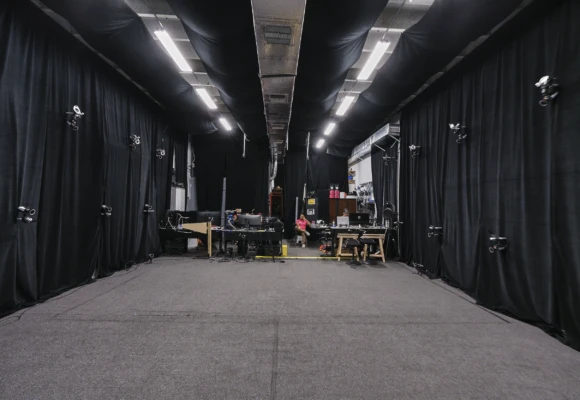 Miami production studio rental with black drapes, open floor space, and lighting setup